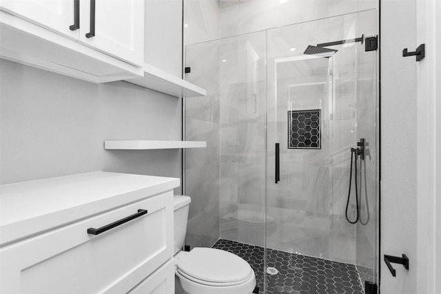 bathroom with toilet and an enclosed shower