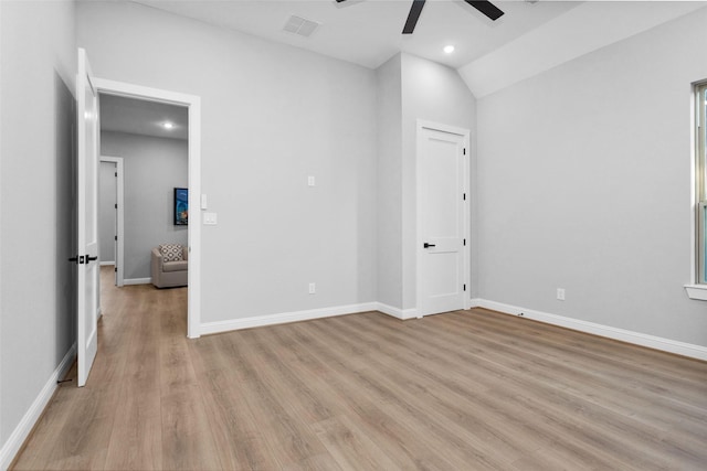 unfurnished bedroom featuring light wood-type flooring, vaulted ceiling, and ceiling fan