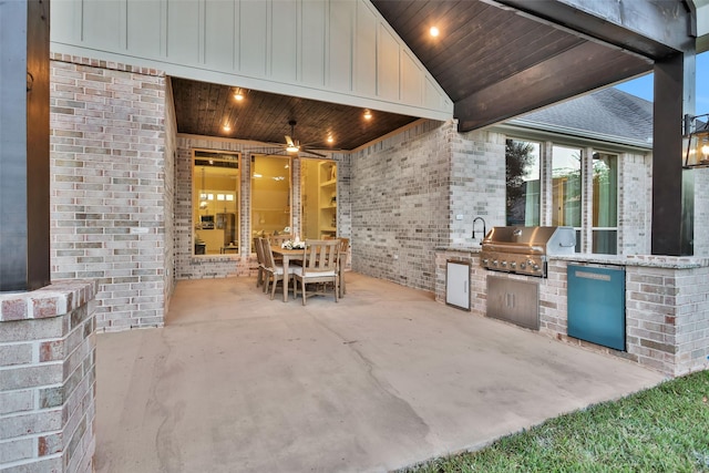 view of patio / terrace with ceiling fan, sink, an outdoor kitchen, and a grill