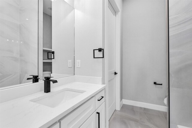 bathroom featuring toilet and vanity