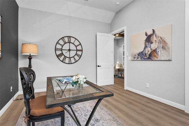 home office featuring hardwood / wood-style flooring and lofted ceiling