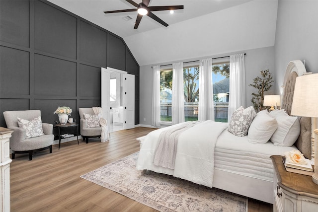 bedroom featuring ceiling fan, lofted ceiling, and light hardwood / wood-style floors