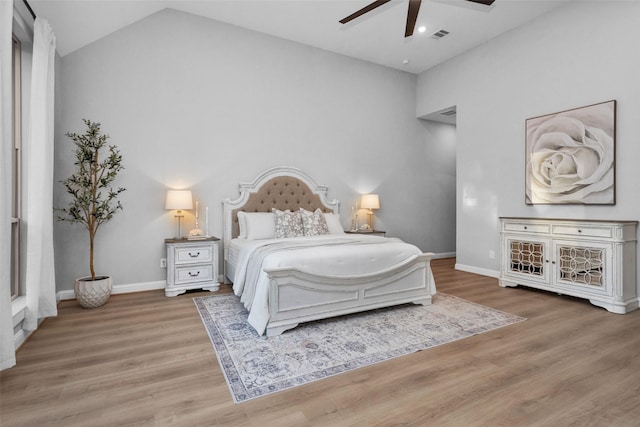 bedroom with wood-type flooring, lofted ceiling, and ceiling fan