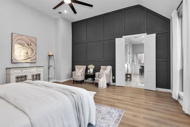 bedroom featuring lofted ceiling, light wood-type flooring, and ceiling fan