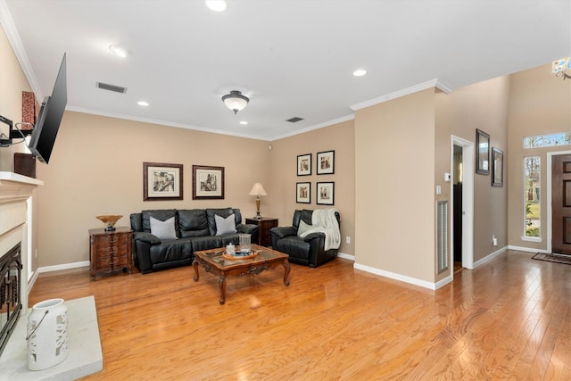 living room featuring crown molding and light wood-type flooring