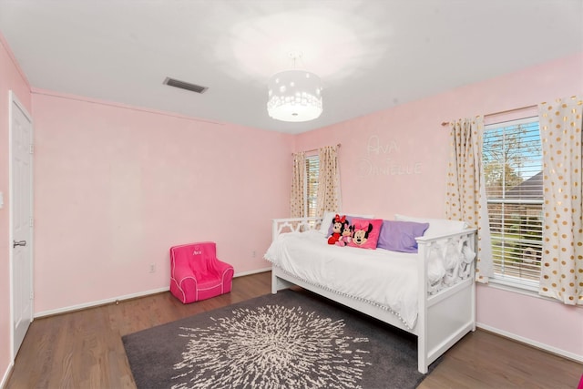 bedroom with dark hardwood / wood-style floors