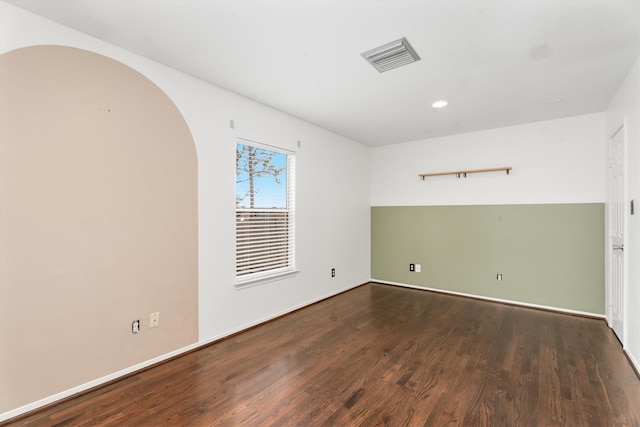 spare room with dark wood-type flooring