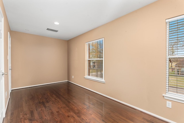 unfurnished room featuring dark wood-type flooring