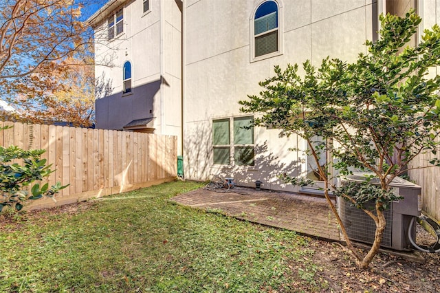 view of yard with cooling unit and a patio area