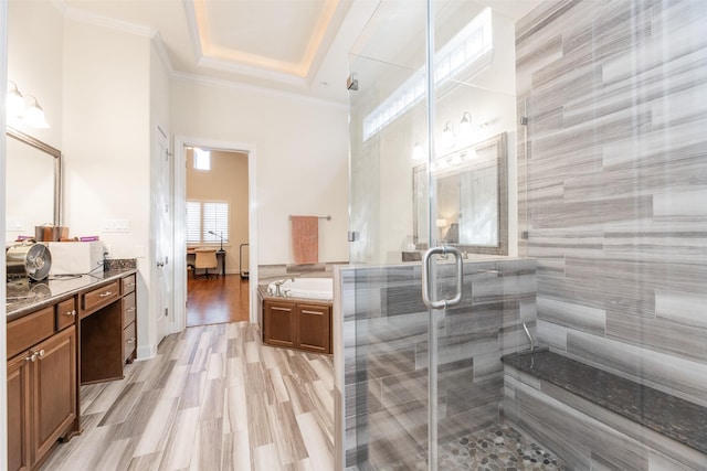 bathroom featuring hardwood / wood-style flooring, vanity, ornamental molding, and plus walk in shower