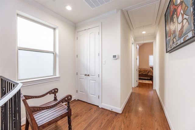 hall featuring crown molding and light wood-type flooring