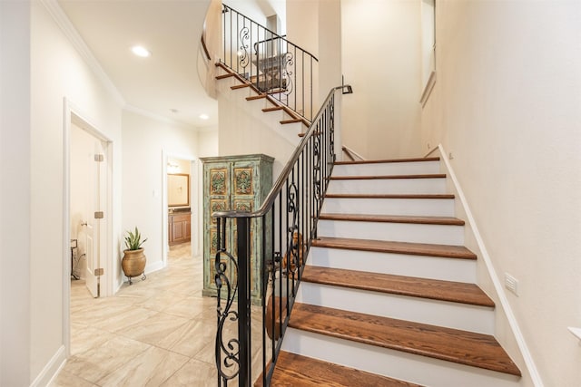 stairs featuring crown molding