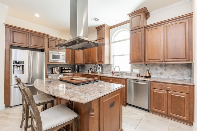 kitchen with a center island, appliances with stainless steel finishes, island exhaust hood, sink, and light stone counters