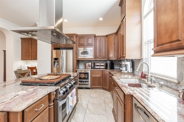 kitchen featuring wine cooler, appliances with stainless steel finishes, sink, island exhaust hood, and light stone countertops