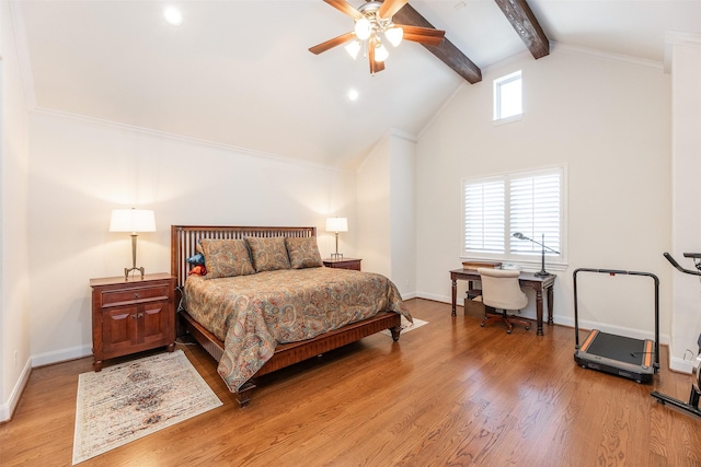 bedroom with light wood-type flooring, ceiling fan, crown molding, and lofted ceiling with beams