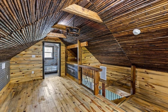 additional living space featuring wood ceiling, hardwood / wood-style flooring, wood walls, and lofted ceiling