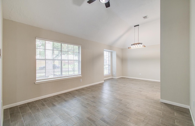 empty room featuring vaulted ceiling and ceiling fan