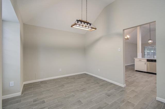 unfurnished room featuring light hardwood / wood-style flooring and lofted ceiling