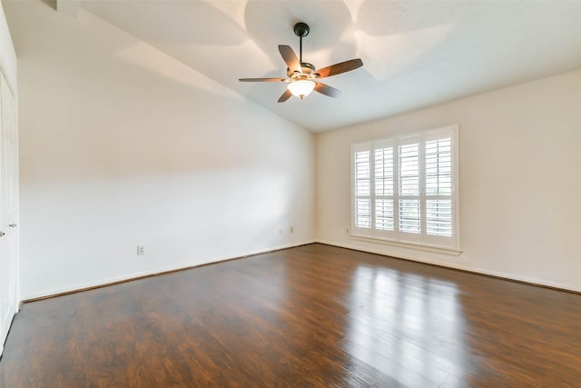 empty room featuring ceiling fan, lofted ceiling, and dark hardwood / wood-style flooring