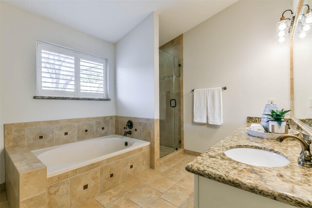 bathroom featuring vanity and independent shower and bath