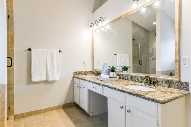 bathroom featuring tile patterned flooring, walk in shower, and vanity