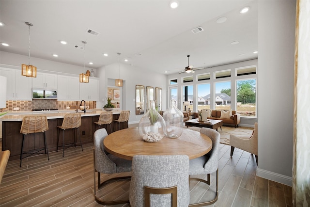 dining area featuring ceiling fan and sink