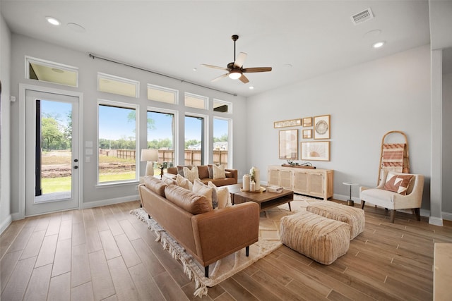 living room with baseboards, visible vents, ceiling fan, wood finished floors, and recessed lighting