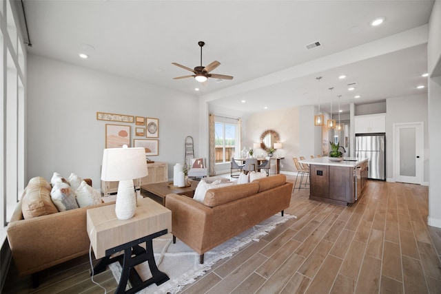 living room featuring ceiling fan, recessed lighting, and wood tiled floor