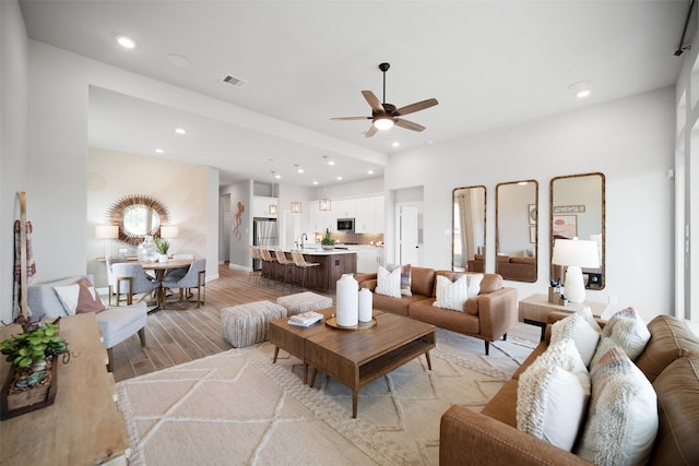 living room featuring recessed lighting, visible vents, ceiling fan, and light wood finished floors