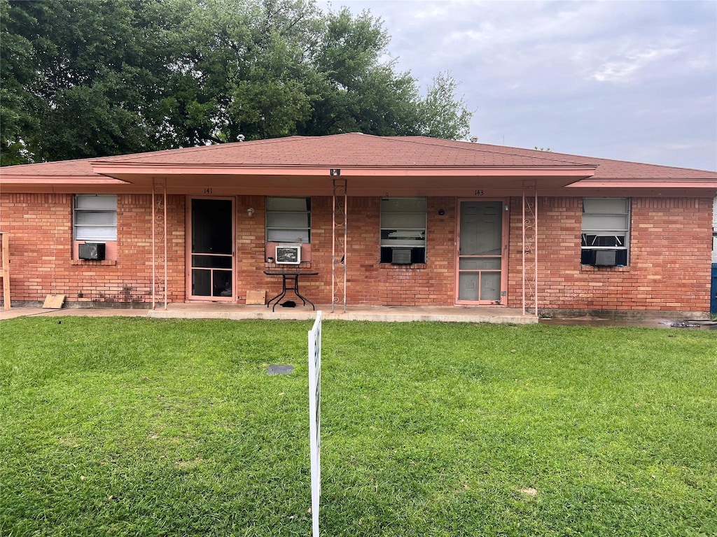 back of property featuring a yard and cooling unit