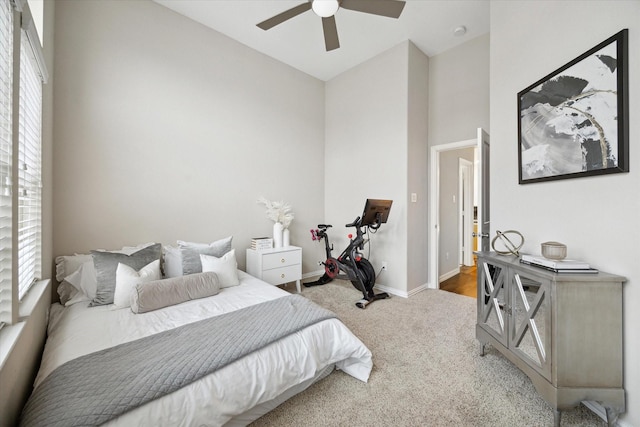 bedroom featuring ceiling fan, multiple windows, lofted ceiling, and carpet