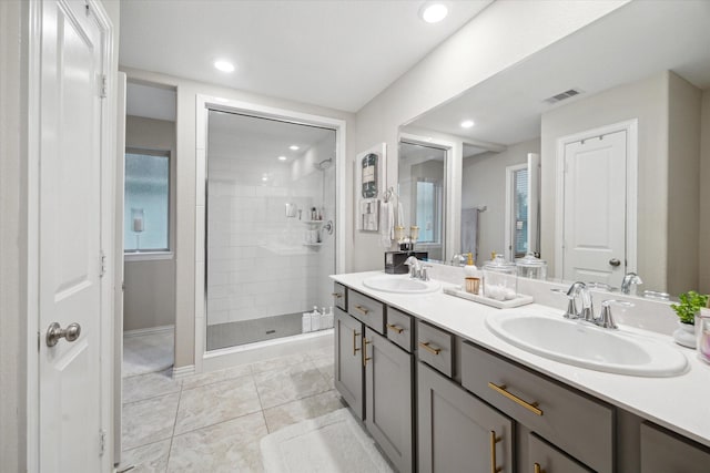 bathroom with tile patterned floors, walk in shower, and vanity