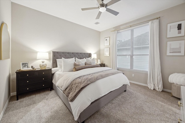 bedroom with ceiling fan and light colored carpet