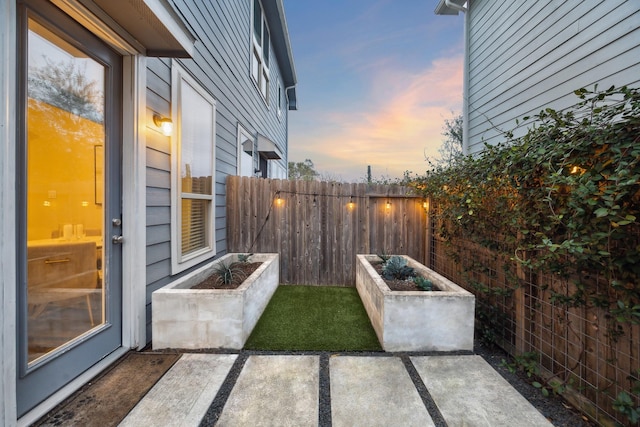 view of patio terrace at dusk