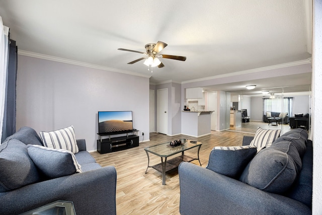 living room featuring ceiling fan, light hardwood / wood-style floors, and ornamental molding