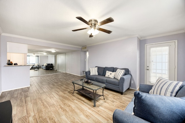 living room featuring light wood-type flooring, ceiling fan, and ornamental molding