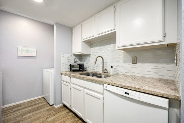 kitchen featuring sink, white cabinetry, dishwasher, and light hardwood / wood-style flooring