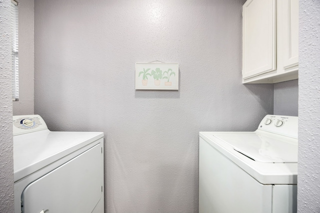 laundry area with cabinets and separate washer and dryer