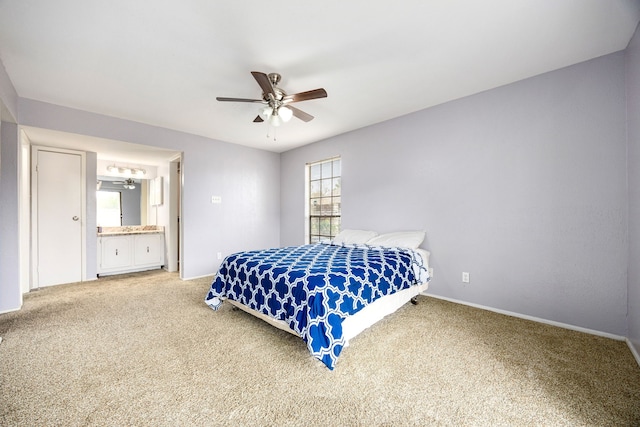 carpeted bedroom with ceiling fan and ensuite bathroom