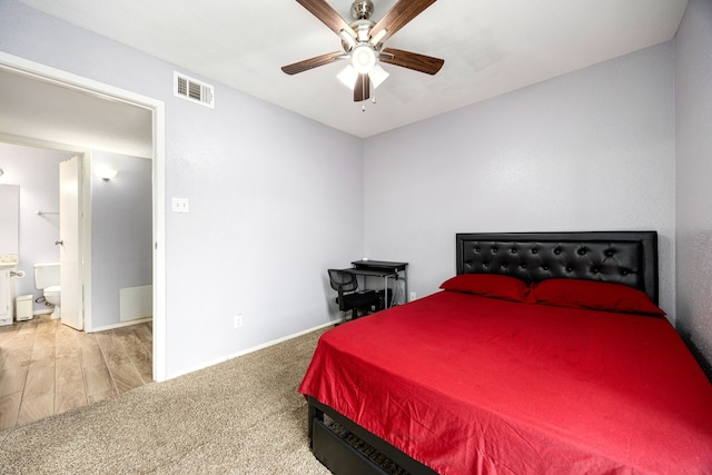 bedroom with ceiling fan, carpet, and ensuite bath