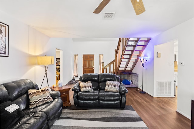 living room featuring hardwood / wood-style floors and ceiling fan