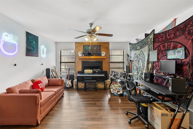 office space with ceiling fan, wood-type flooring, and wood walls