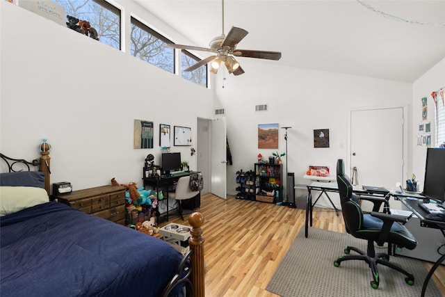 bedroom featuring ceiling fan, high vaulted ceiling, and hardwood / wood-style flooring