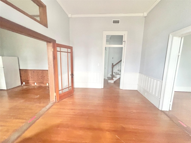 hallway with hardwood / wood-style flooring and ornamental molding