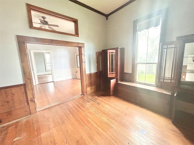 unfurnished room with light wood-type flooring and ornamental molding