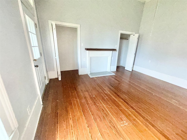 unfurnished living room featuring dark hardwood / wood-style flooring