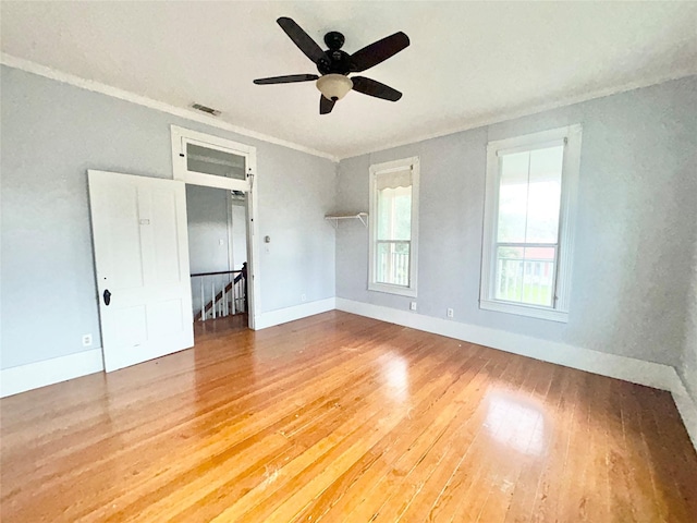 unfurnished bedroom featuring hardwood / wood-style flooring, ceiling fan, and ornamental molding