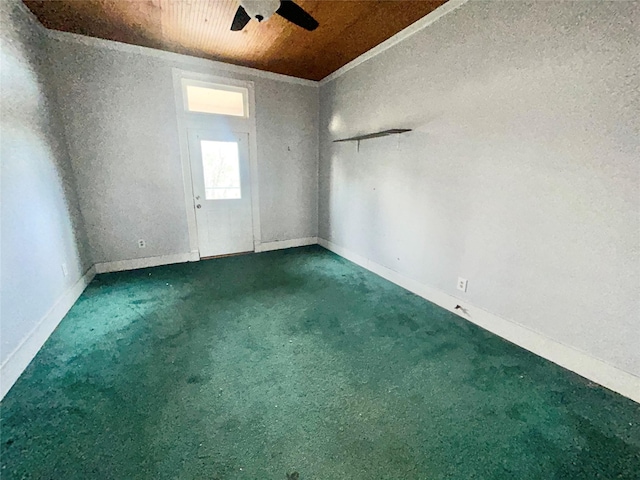 unfurnished room with ceiling fan, wooden ceiling, and carpet