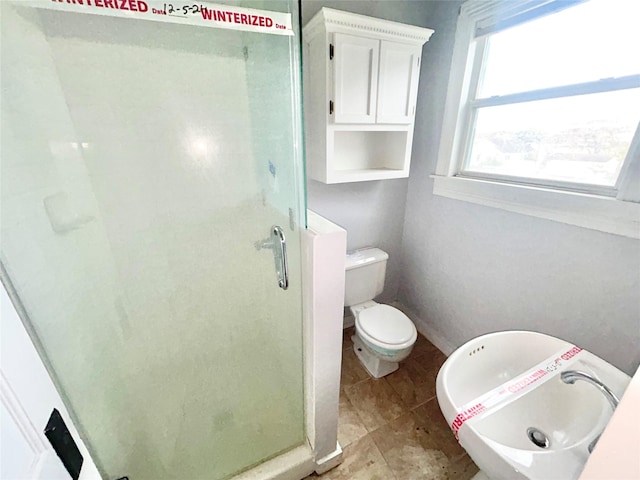 bathroom with an enclosed shower and toilet