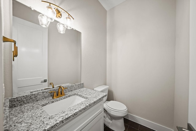 bathroom with toilet, tile patterned floors, and vanity